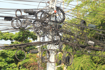 Messy cable electricity post.