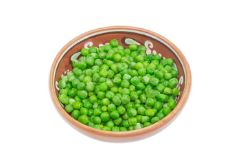 Green peas in ceramic bowl on a light background