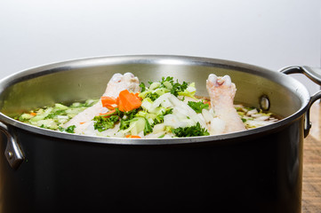 Chicken soup ingredients in cook pot