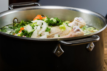 Chicken soup ingredients in cook pot