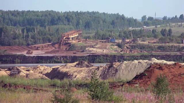 Industrial landscape. Gold mining in Ural mountains near Nevyansk. Dredge separator on river dragging gold sand