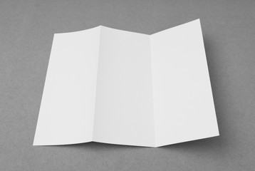 Trifold white template paper on gray  background .