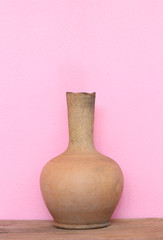 Brown Pottery Vase on wooden plank table.