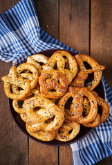 Oktoberfest salted soft pretzels in a plate from Germany on wooden background. Top view