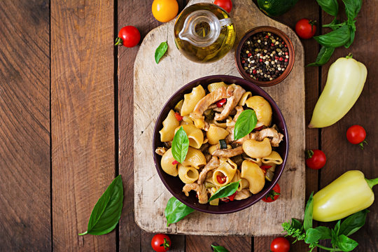 Pasta Gomiti Rigati with meat and vegetables in an Asian style. Top view