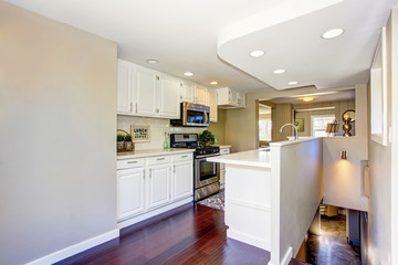 Classic American kitchen room with white cabinets and hardwood floor