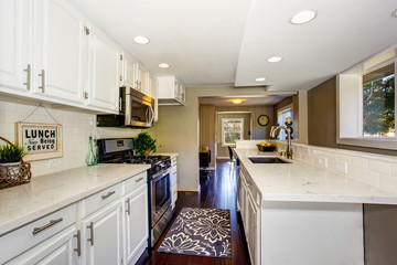 Classic American kitchen room with white cabinets and hardwood floor