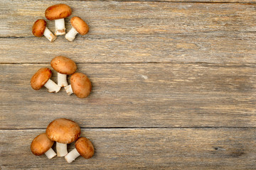 champignon mushrooms on a wooden boards background