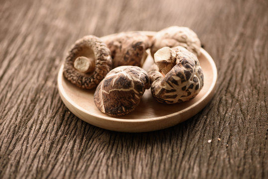 dried shiitake mushroom in wood bowl