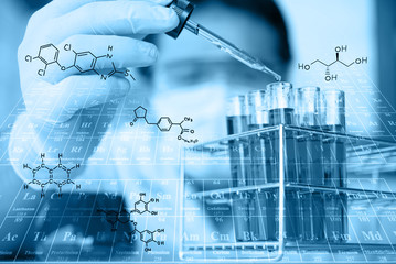 Glass laboratory chemical test tubes with red liquid.Man wears p
