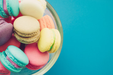 Colorful france macarons on blue background.