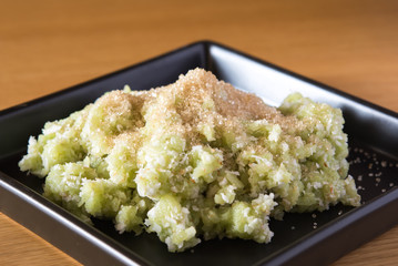 shredded rice grain and sugar on black plate