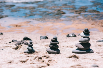 Stones balance on vintage beach, inspirational summer landscape.