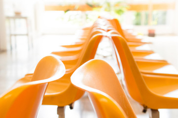 Doctor's waiting room with chairs and potted plant