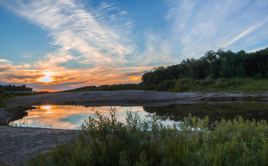 The reflection of the sunset in a small pond