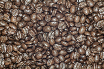 Coffee beans closeup. Roasted brown coffee beans texture or coffee beans background for design.