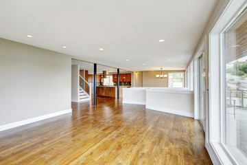 Open floor plan. Empty living room interior in light tones