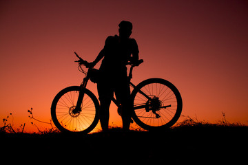 Plakat sunset and silhouette backlight bikers