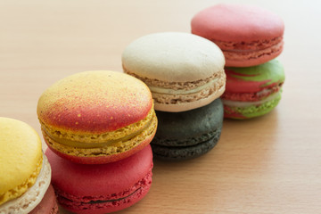 Fototapeta na wymiar Colorful france macarons on wooden desk background.