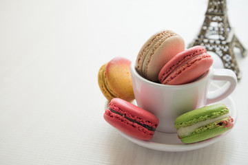 Colorful france macarons on white desk background.
