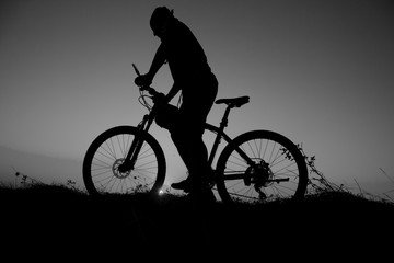 Obraz na płótnie Canvas sunset and silhouette backlight bikers