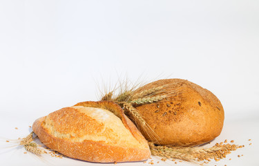 Bread with ears of wheat on a white background