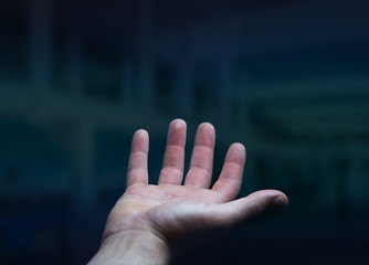 Businessman hand on black dark background