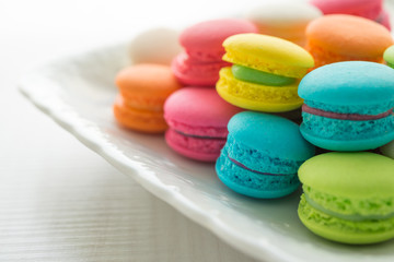 Fototapeta na wymiar Colorful france macarons on white vintage dish.