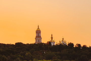 Kyiv pechersk lavra with golden cupola at sunset