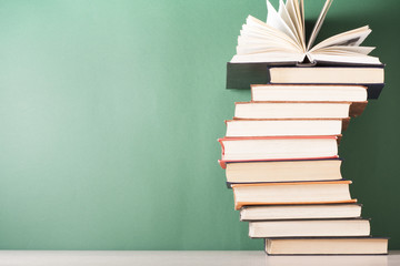 Open book, hardback books on wooden table. Education background. Back to school. Copy space for text.