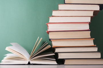 Open book, hardback books on wooden table. Education background. Back to school. Copy space for text.