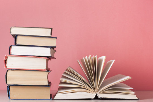 Open book, hardback books on wooden table. Education background. Back to school. Copy space for text.