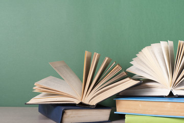 Open book, hardback books on wooden table. Education background. Back to school. Copy space for text.