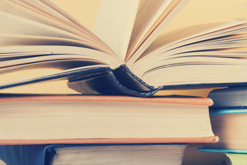 Open book, hardback books on wooden table. Education background. Back to school. Copy space for text.