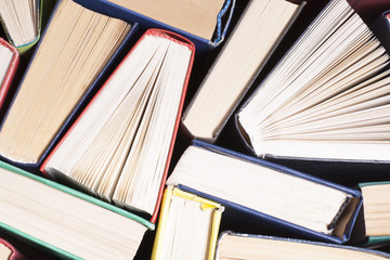 Fototapeta premium Open book, hardback books on wooden table. Education background. Back to school. Copy space for text.