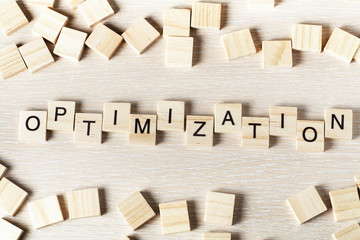 Optinization word written on wood block. Wooden abc