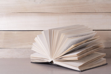 Open book, hardback books on wooden table. Education background. Back to school. Copy space for text.