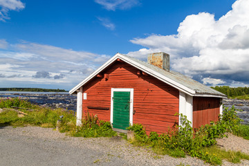 Fototapeta na wymiar Fisherman's hut along the Tornionjoki river on the border of Sweden and Finland