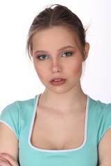 Girl with makeup wearing blue T-shirt. Close up. White background