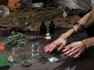 Work hereditary Sage. Find people on photos. Hands witch. working table magician. Photo missing...