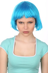 Serious girl with blue hair looking into the camera. Close up. White background