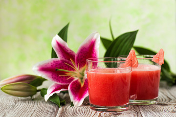 Obraz na płótnie Canvas Glass of watermelon smoothie with lily
