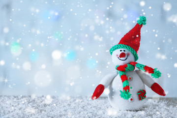 Cute snowman on Christmas background. Snow effect