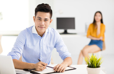 young smiling business man  working in office