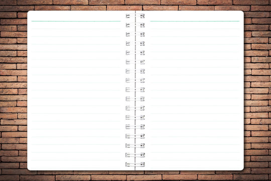 Open notebook paper with line on brick wall background for design with copy space for text or image.