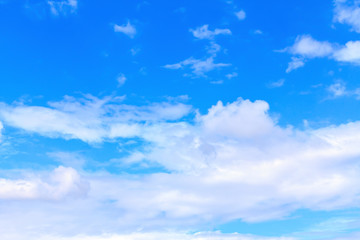 Blue sky background with white clouds. The vast blue sky and clouds sky on sunny day. White fluffy clouds in the blue sky.