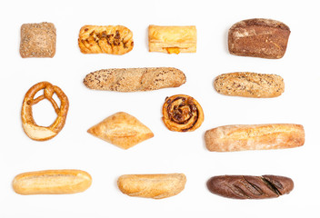 various freshly baked buns and loaves on white
