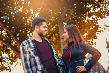 Fototapeta premium Young couple spends time in the autumn park