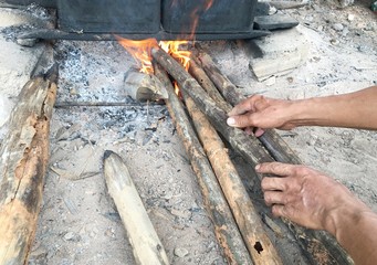 kindle fire for boil bamboo shoot in BUCKET PAIL