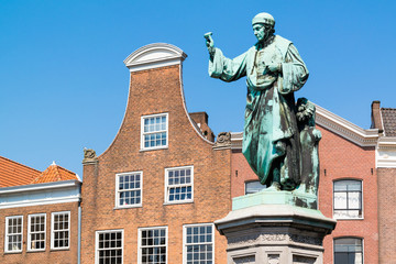 Fototapeta na wymiar Statue of Laurens Janszoon Coster and bell gable of old house on Grote Markt market square in downtown Haarlem, Netherlands